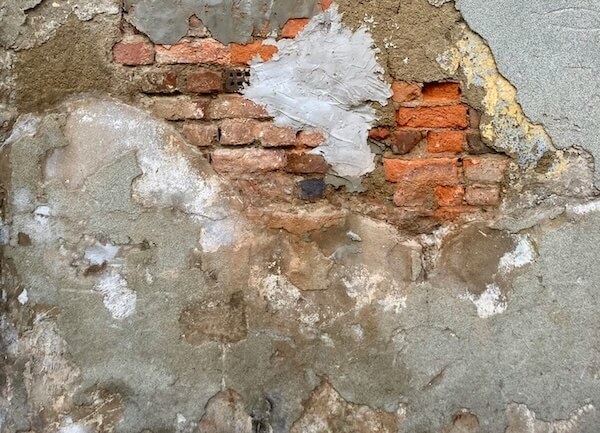 Photo of a run down brick wall