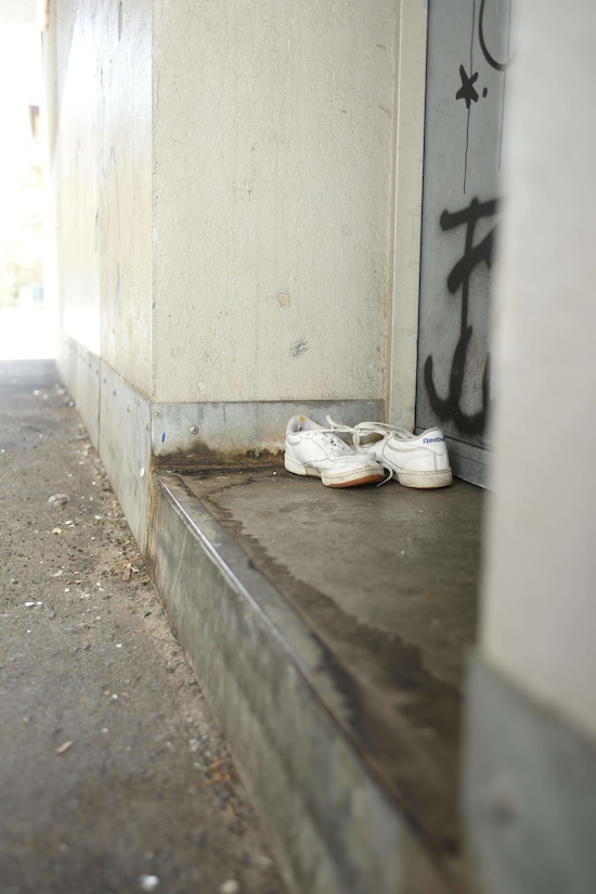 Photo by Chiara S of a pair of old white sneakers on a doorstep